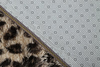 Underside of the Fauna Shag Rug folded back to show the ethylene vinyl acetate backing and the overlocked binding tape along the edge