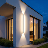 Vina wall light washing light beside a front door at dusk