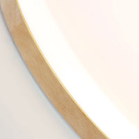 Close detail of the wood grain rim and acrylic diffuser edge on the Nolla ceiling light