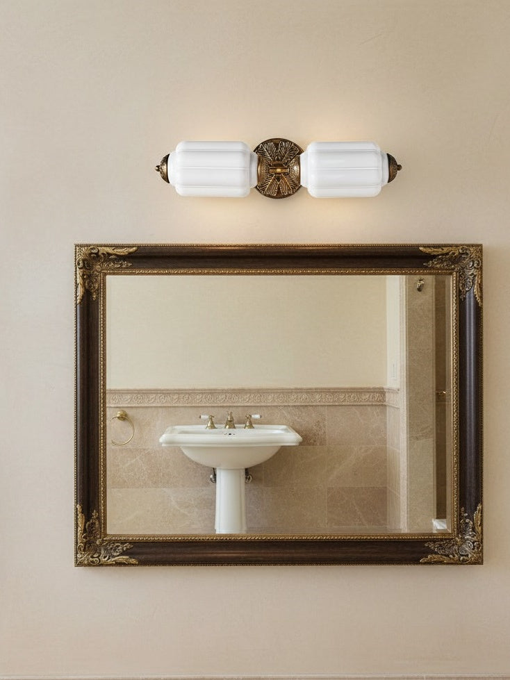 Lanto Horizontal Milk Glass Wall Light above a framed mirror and pedestal basin in a classic bathroom