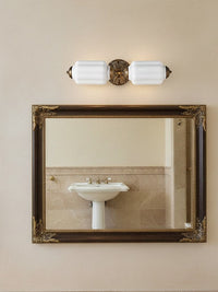 Lanto Horizontal Milk Glass Wall Light above a framed mirror and pedestal basin in a classic bathroom