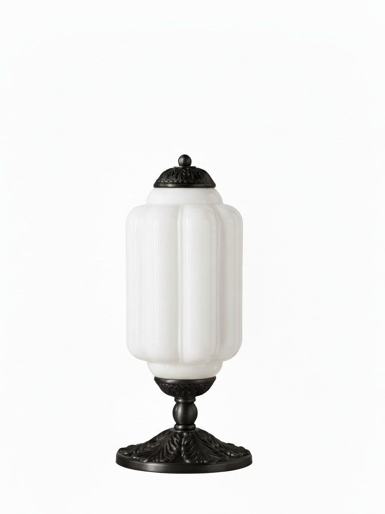 Elva glass table lamp with white opal glass body and black cast metal base on a plain background