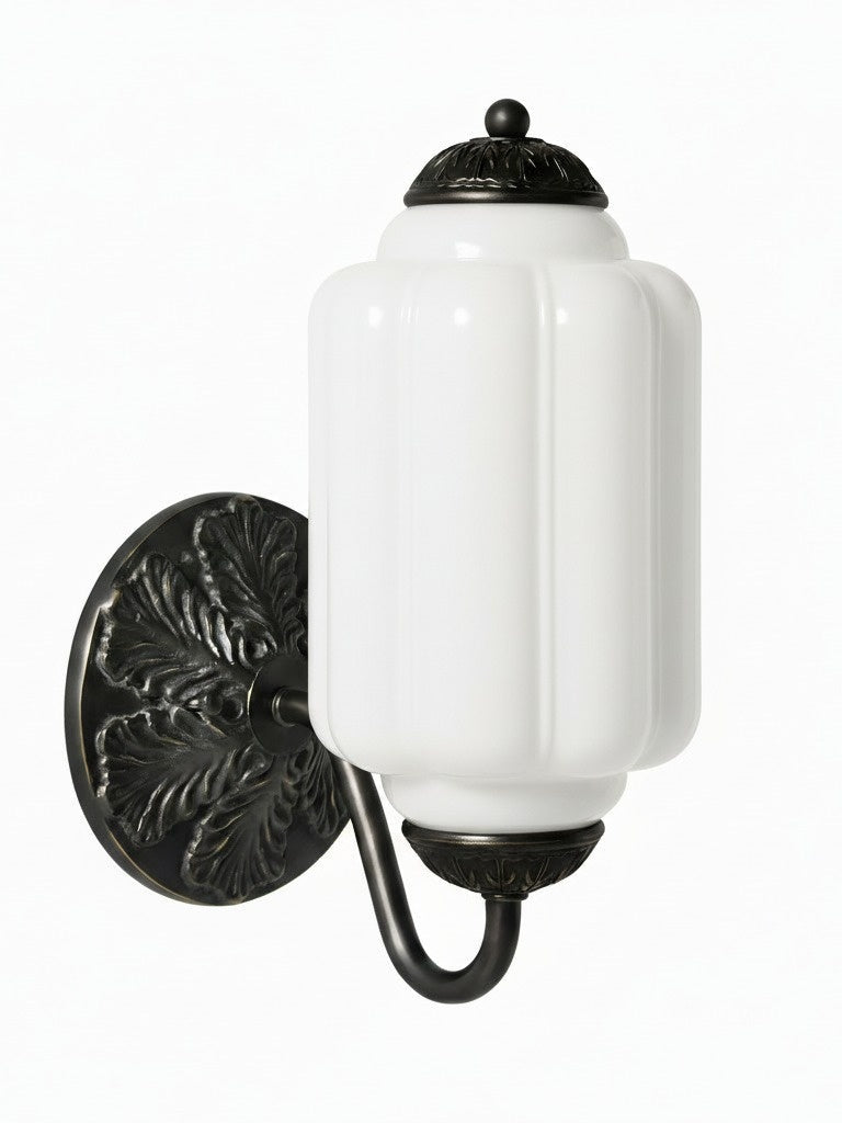 Elva milk glass wall sconce with black backplate on a plain white background
