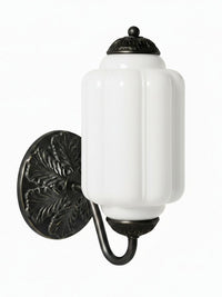Elva milk glass wall sconce with black backplate on a plain white background