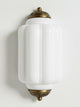 Faro Flush Milk Glass Wall Light with ribbed white glass shade and aged copper caps on a white background